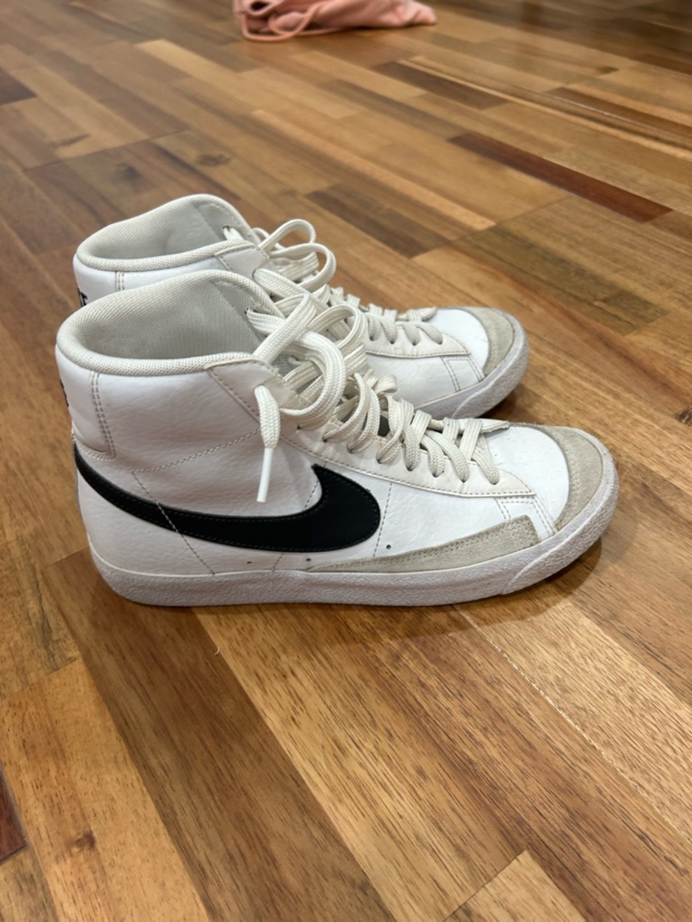Nike White High-Top Sneakers with Black Swoosh